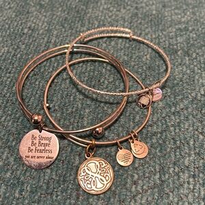 Three bangle bracelets, two are Alex and Ani